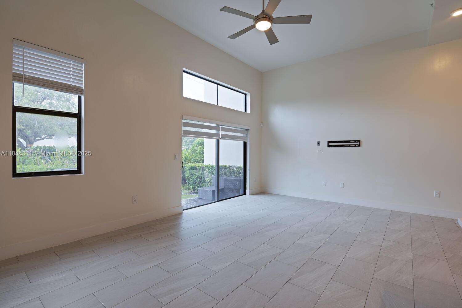 891 Northwest 45th Terrace Plantation, FL 33317 - Photo 7 of 33 an empty room with windows and fan