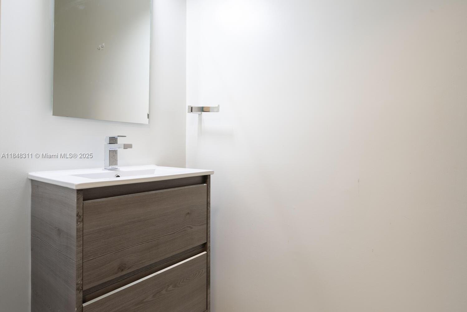 891 Northwest 45th Terrace Plantation, FL 33317 - Photo 10 of 33 a bathroom with a sink and a mirror