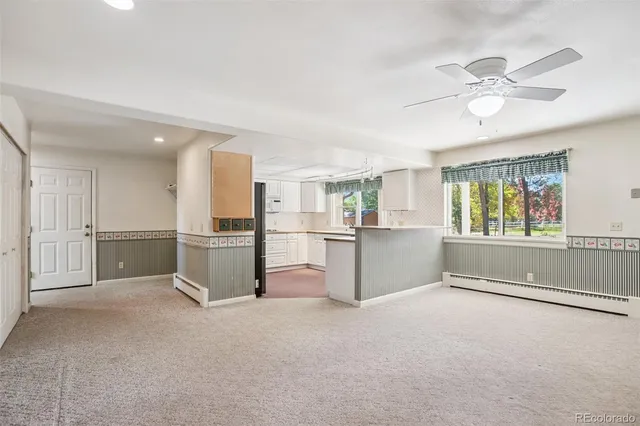 a view of a kitchen with refrigerator and microwave