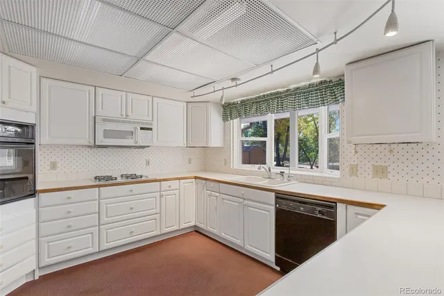 a kitchen with sink cabinets and window