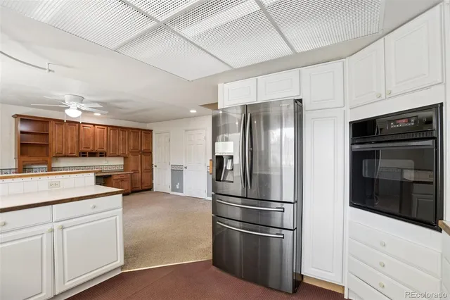 a kitchen with stainless steel appliances and white cabinets