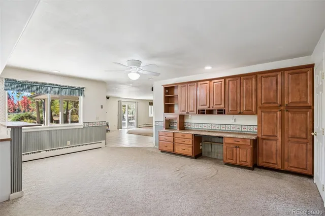 a large white kitchen with stainless steel appliances granite countertop a refrigerator and a stove top oven