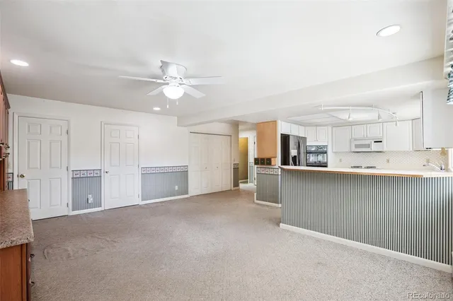 a view of a kitchen with a sink and a cabinet