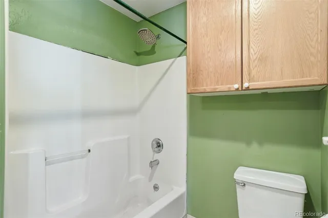 a bathroom with a toilet and a bathtub