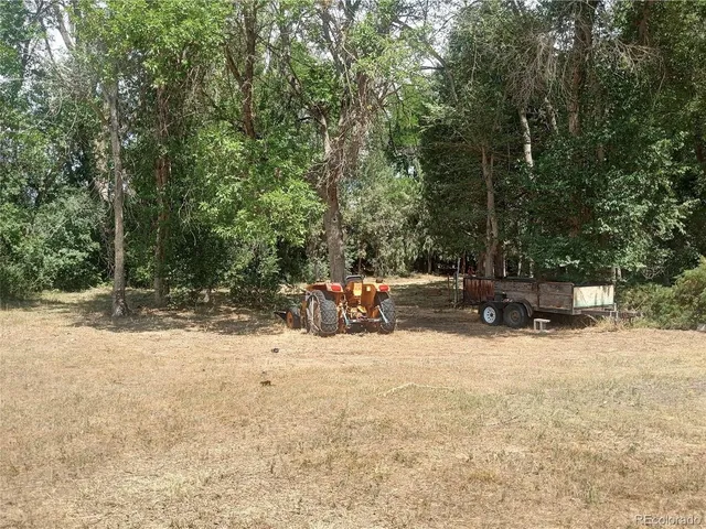 a view of the patio with a table and chairs under an umbrella