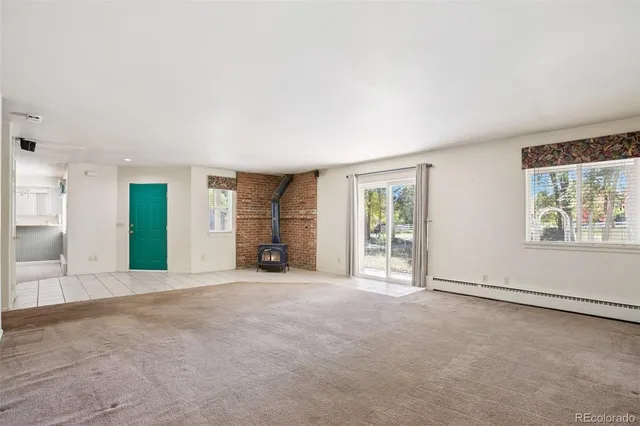 an empty room with windows and closet