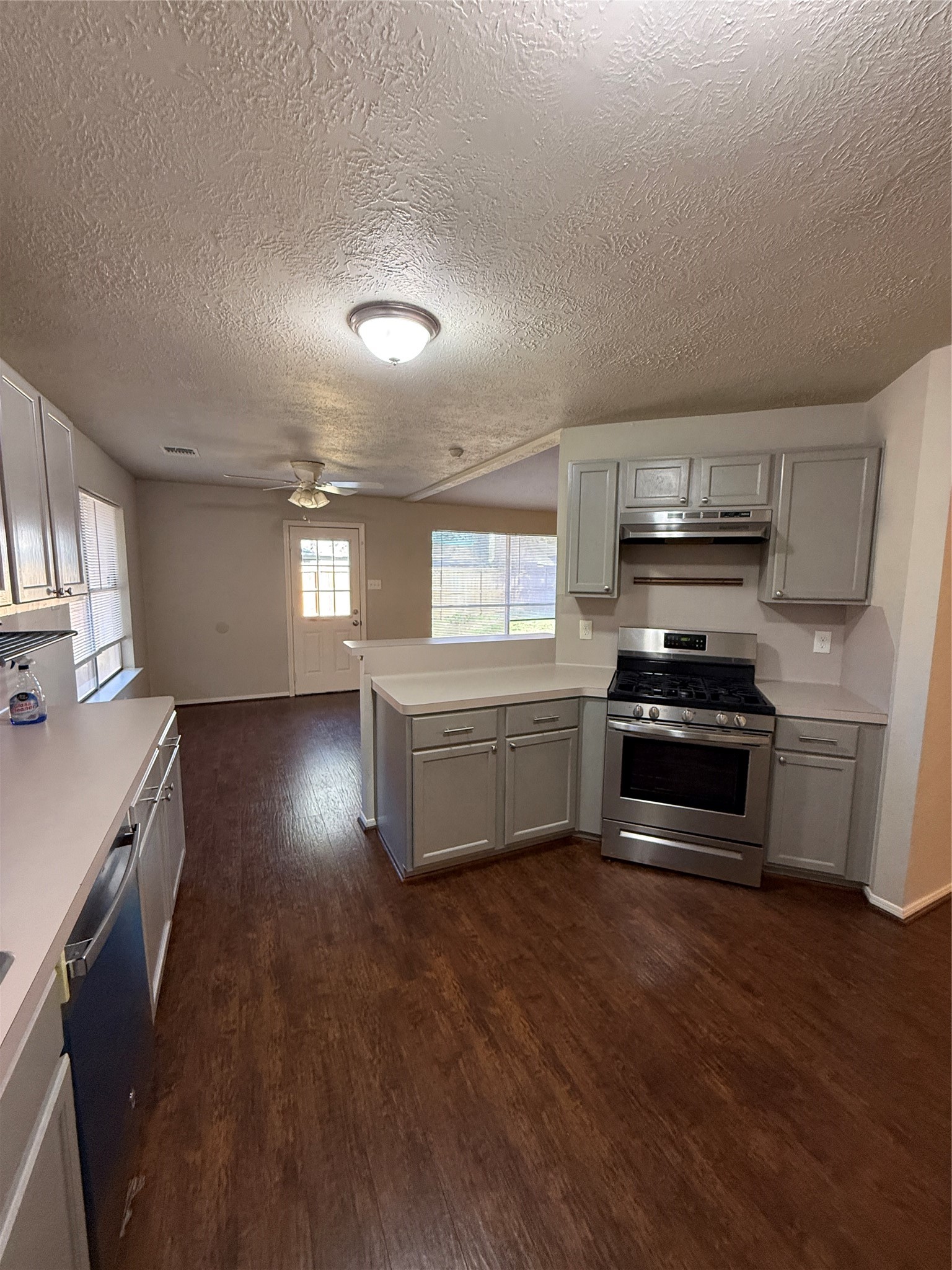 5026 Tealgate Drive Spring, TX 77373 - Photo 9 of 22 a kitchen with granite countertop a stove and a wooden floors