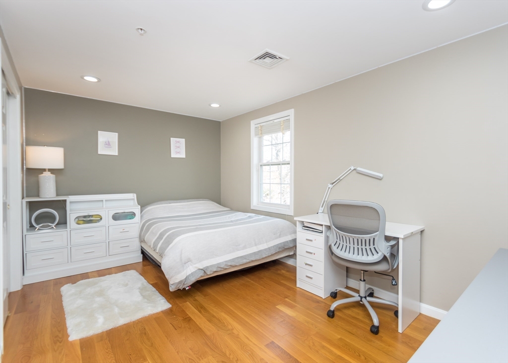 985 Trapelo Road, Unit 23 Waltham, MA 02452 - Photo 15 of 27 a bedroom with a bed and cabinets