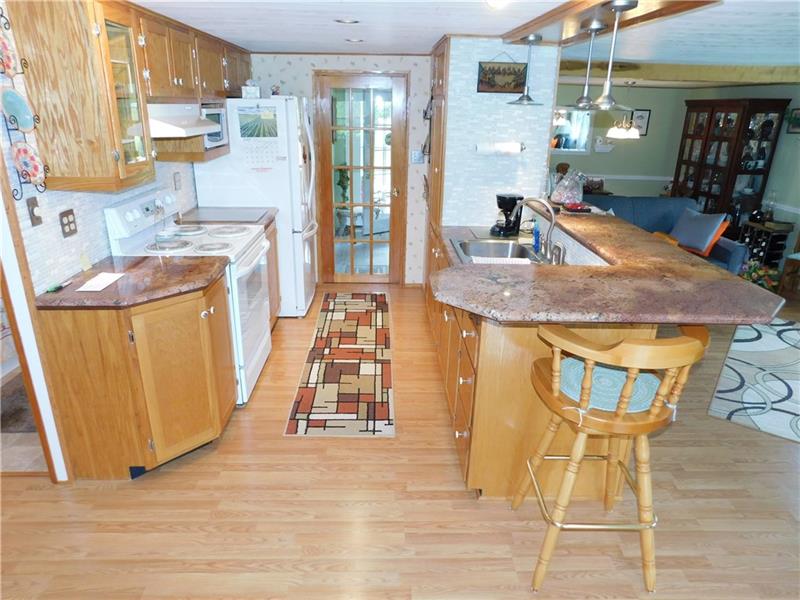 162 Shenango Park Road Transfer, PA 16154 - Photo 7 of 20 NEWER KITCHEN WITH BREAKFAST BAR, GRANITE COUNTER, NEW BACK SPLASH (TILED)