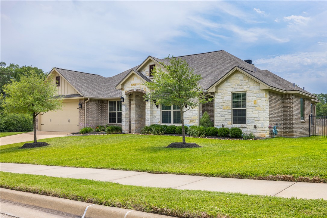 2001 Lexi Lane Bryan, TX 77807 - Photo 1 of 1 a front view of a house with a yard and garage