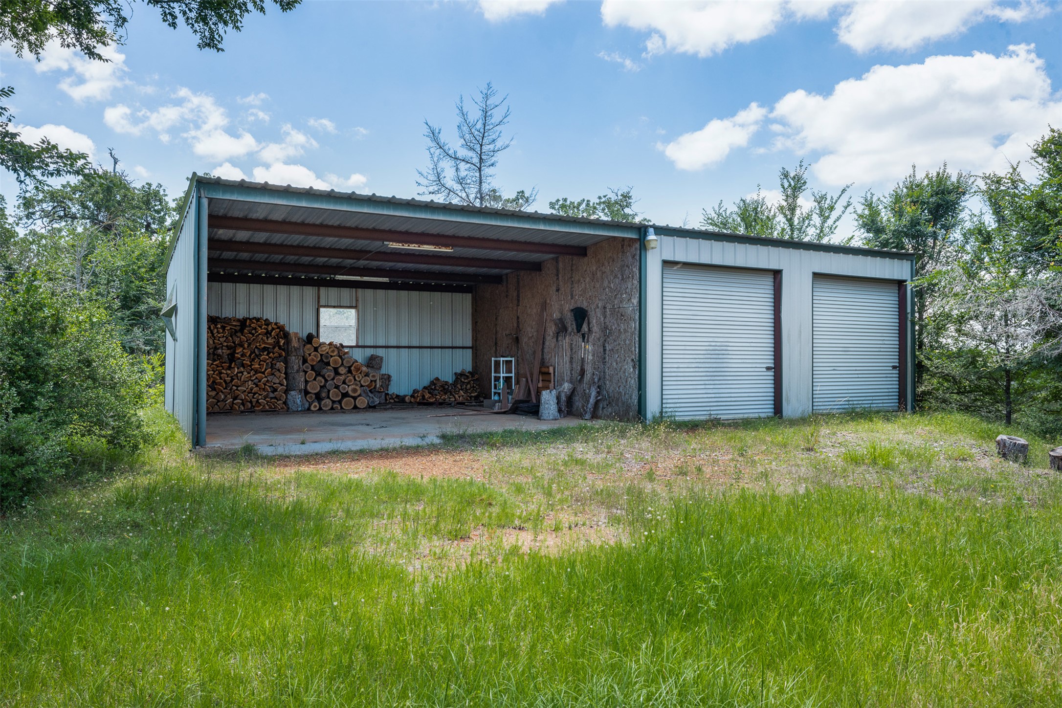 1004 22 Hills Road Gause, TX 77857 - Photo 8 of 37 A spacious utility shed offers ample storage and covered workspace.