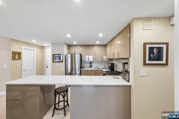 a large kitchen with stainless steel appliances lots of counter space and a refrigerator