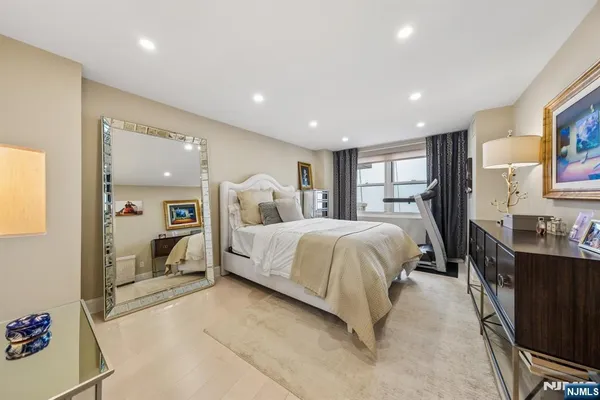 a bedroom with a large bed and a large window