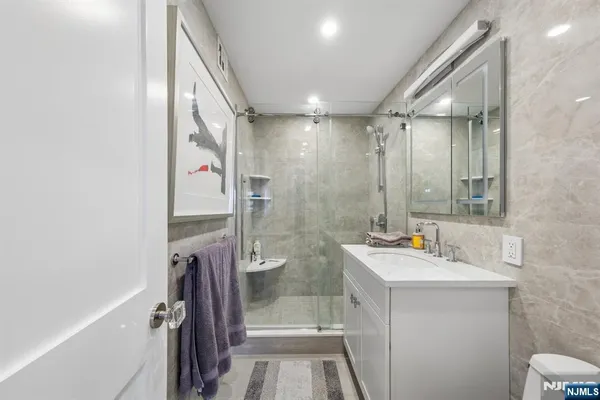 a bathroom with a sink a toilet and shower