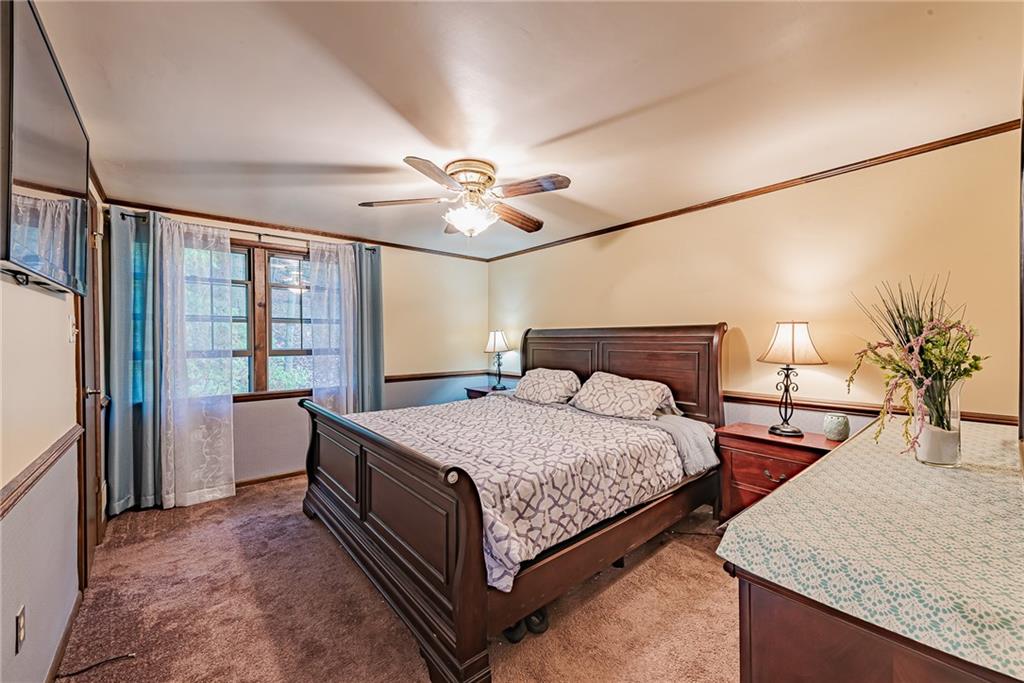 161 Seventh Street Extension Trafford, PA 15085 - Photo 14 of 23 a bedroom with a large bed and a chandelier
