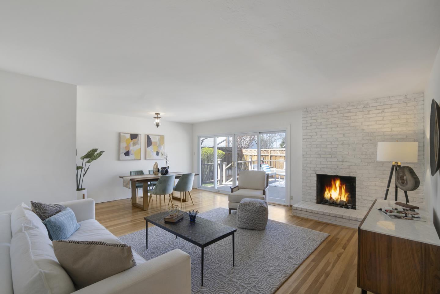 2417 Scanlan Place Santa Clara, CA 95050 - Photo 2 of 22 a living room with furniture flat screen tv and a fireplace