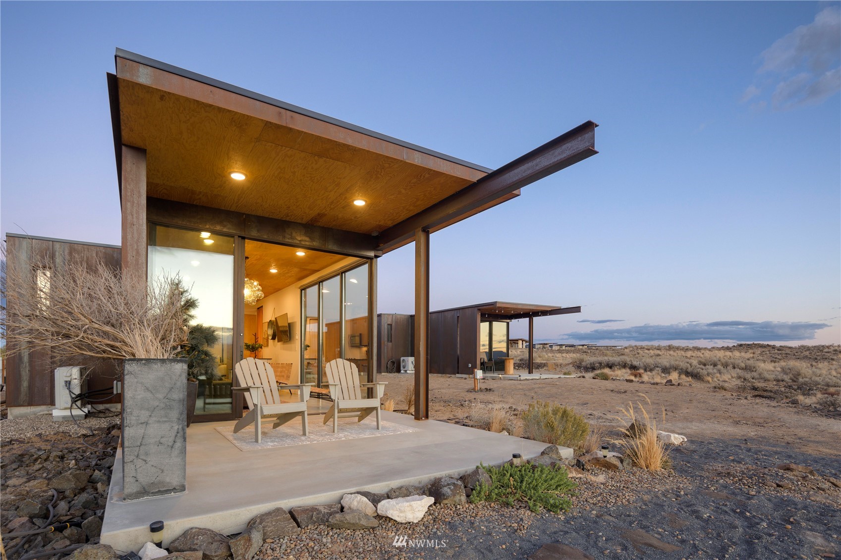 23732 Northwest Cliffe Pointe Road, Unit 1D Quincy, WA 98848 - Photo 12 of 18 a view of a patio with table and chairs floor to ceiling window and an outdoor space