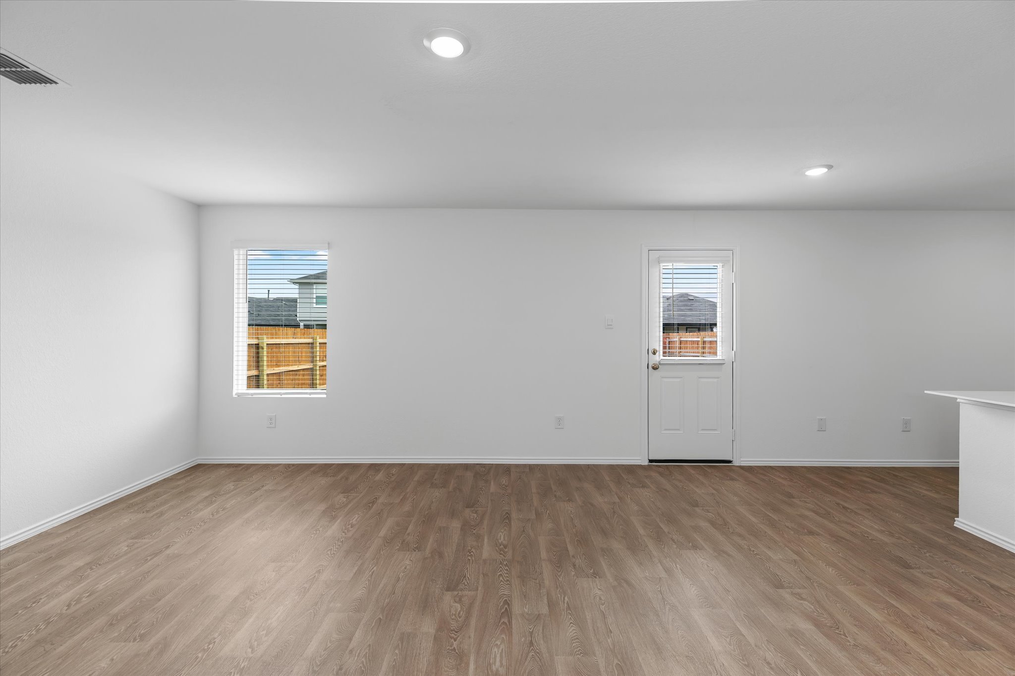 456 Sandringham Loop Kyle, TX 78640 - Photo 28 of 40 A spacious, open concept living area awaits with durable wood-look flooring and ample natural illumination.