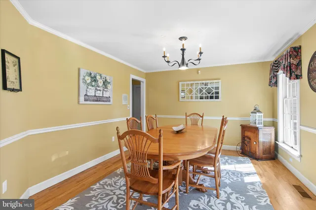 a living room with furniture a ceiling fan and a window