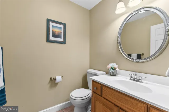 a view of a dining room and livingroom with furniture wooden floor a chandelier