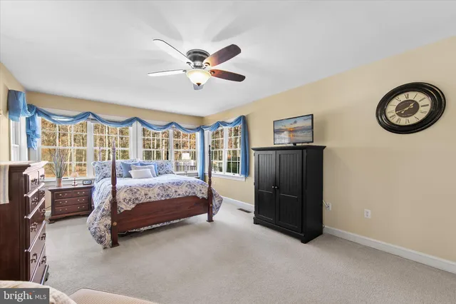 a bathroom with a sink mirror and a window