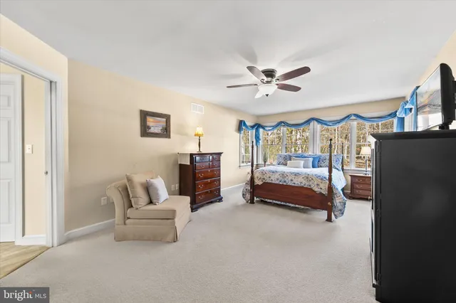 a bedroom with a large bed and a chandelier