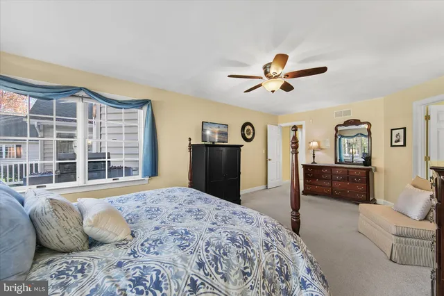 a bedroom with bed and windows