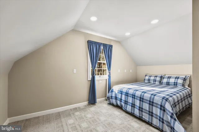 a front view of a house with a garden and deck