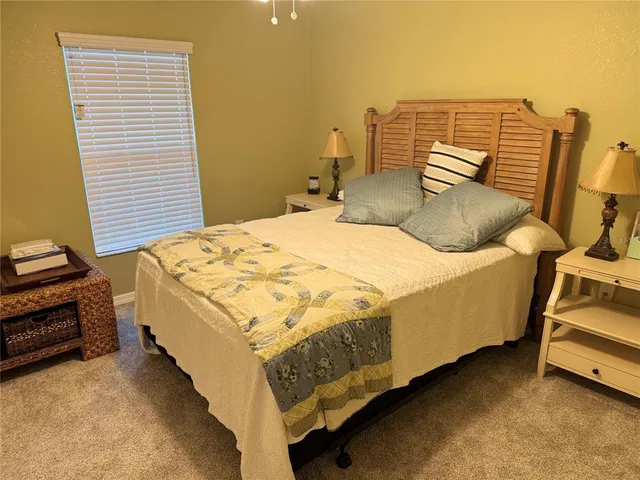 a bedroom with a bed and a night stand