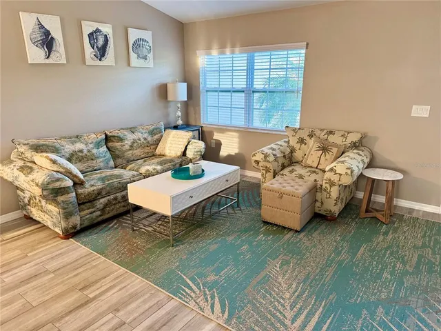 a living room with furniture and a large window