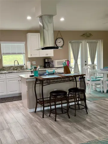 a kitchen with a table chairs sink and cabinets