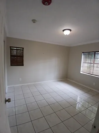 a bathroom with a sink toilet and window