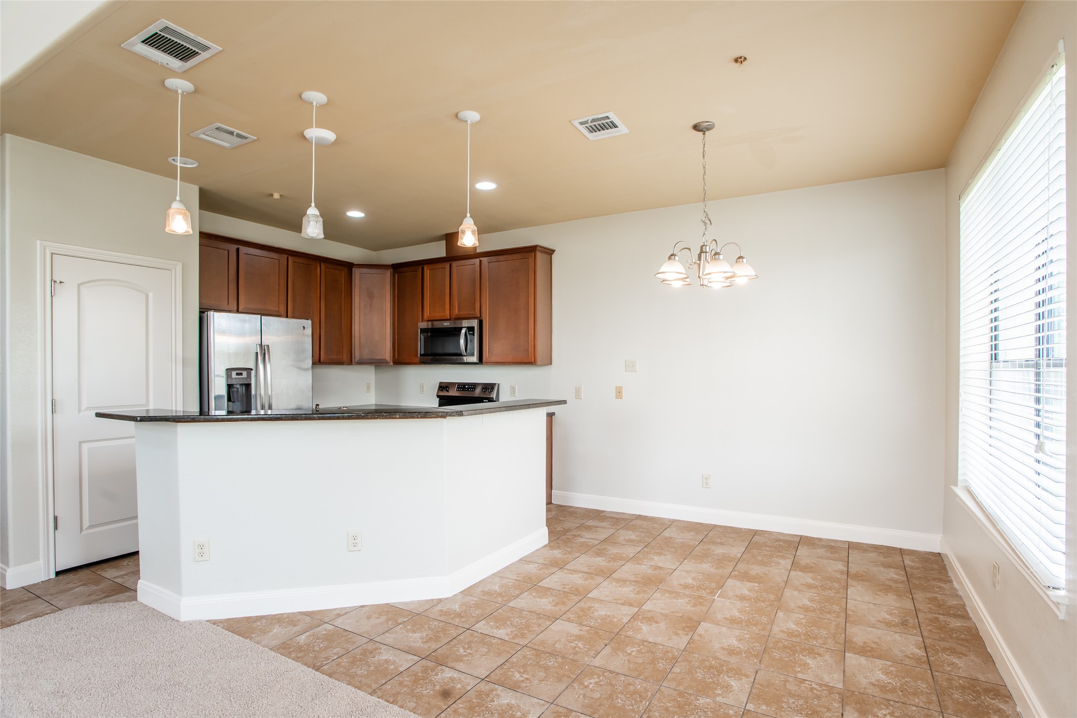 1010 Immanuel Road, Unit 128 Pflugerville, TX 78660 - Photo 5 of 17 An open-concept living space integrates a well-appointed kitchen with an inviting dining area.