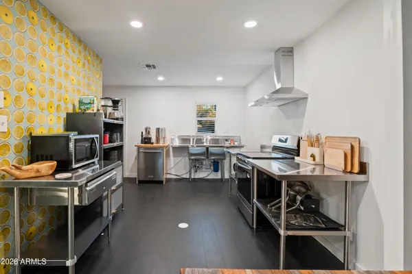 a room with stainless steel appliances a stove a sink and a refrigerator