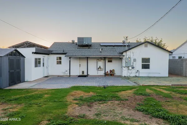 a view of a house with a big yard plants and large trees