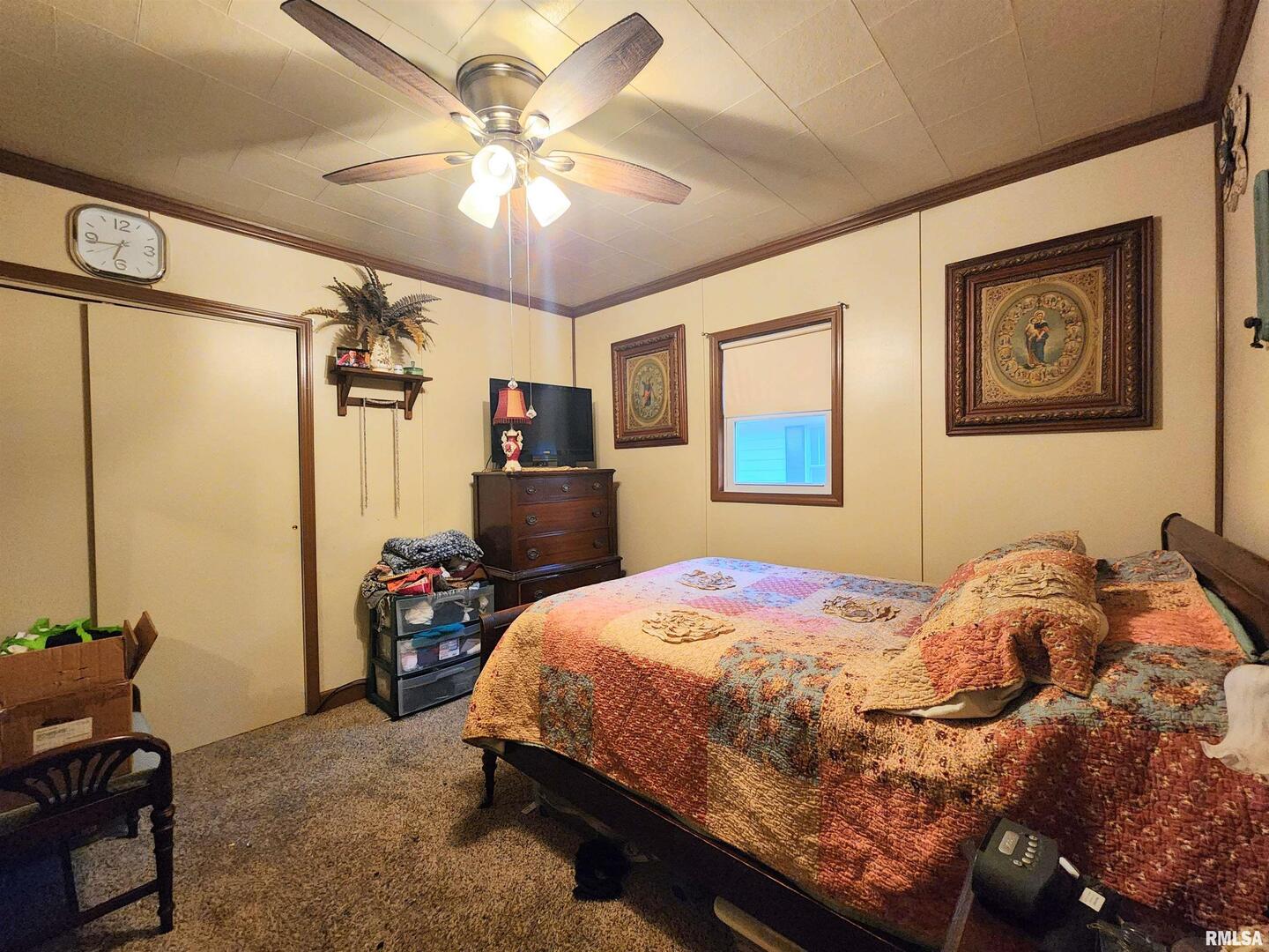 413 North 8th Street Herrin, IL 62948 - Photo 2 of 8 a bedroom with a bed and a chandelier