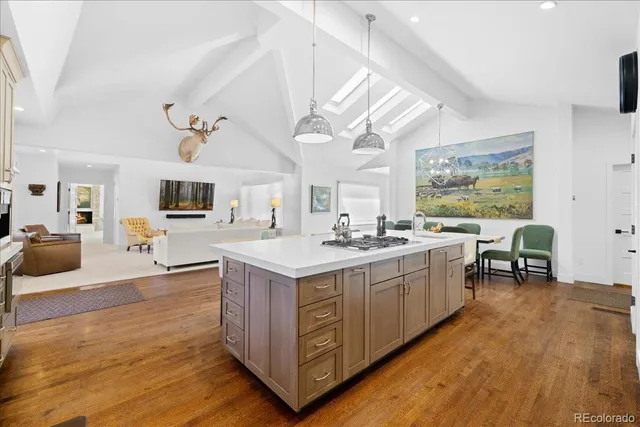 a kitchen with sink stove and wooden floor