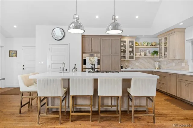 a kitchen with a dining table chairs sink and cabinets