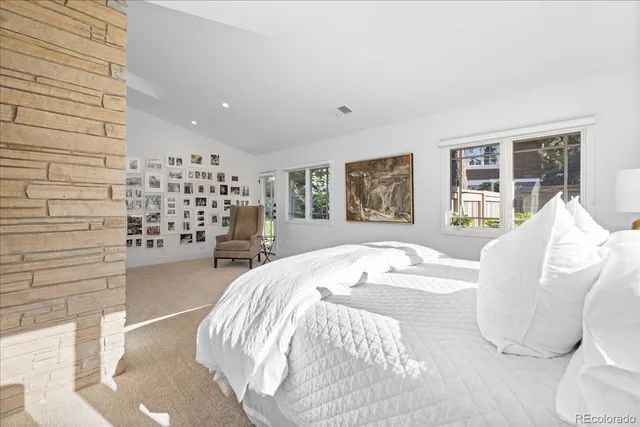 a spacious bedroom with a bed and a cabinets