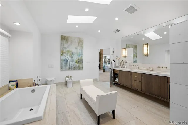 a large bathroom with a large tub sink and vanity