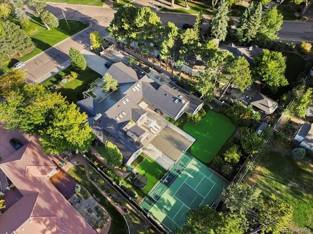 an aerial view of a residential houses with yard