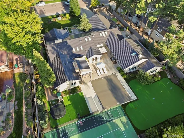 an aerial view of a house with garden space and street view