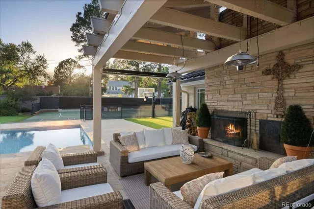 a outdoor space with patio the couches and a fireplace
