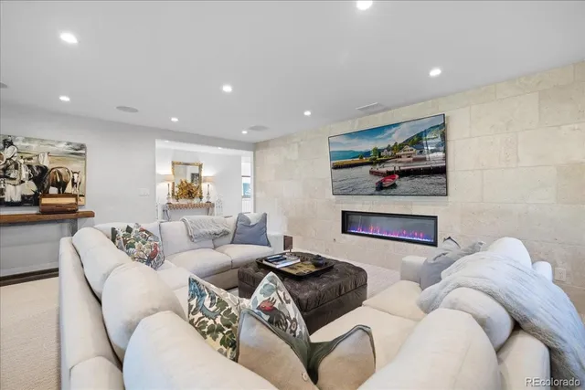 a living room with furniture and wall paintings