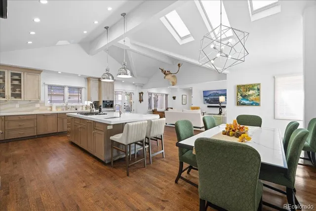 a living room with furniture kitchen view and a chandelier