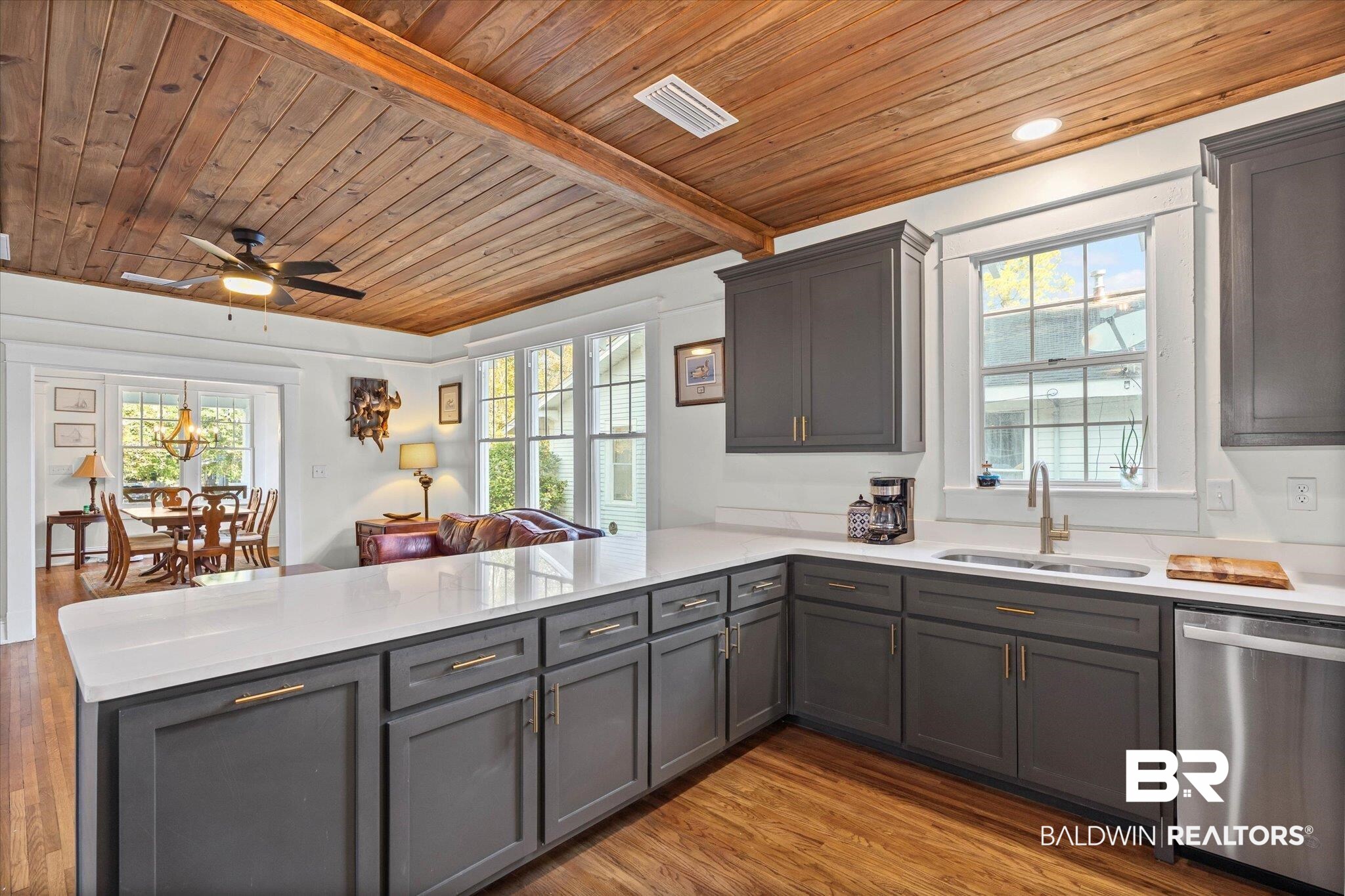 11 South Lafayette Street Mobile, AL 36604 - Photo 19 of 20 Kitchen with stainless steel dishwasher, a wooden ceiling with exposed beams, dark wood finished floors, a peninsula, and open floor plan