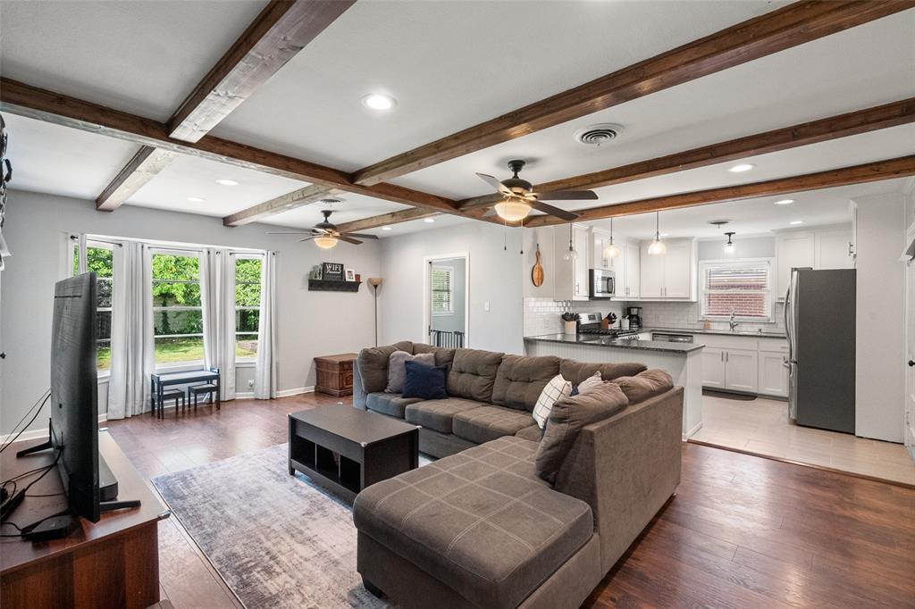 803 South Rusk Street Gainesville, TX 76240 - Photo 1 of 1 Living room with a ceiling fan, light wood-style floors, recessed lighting, beamed ceiling, and baseboards