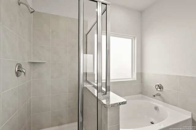 a bathroom with a bathtub and a shower