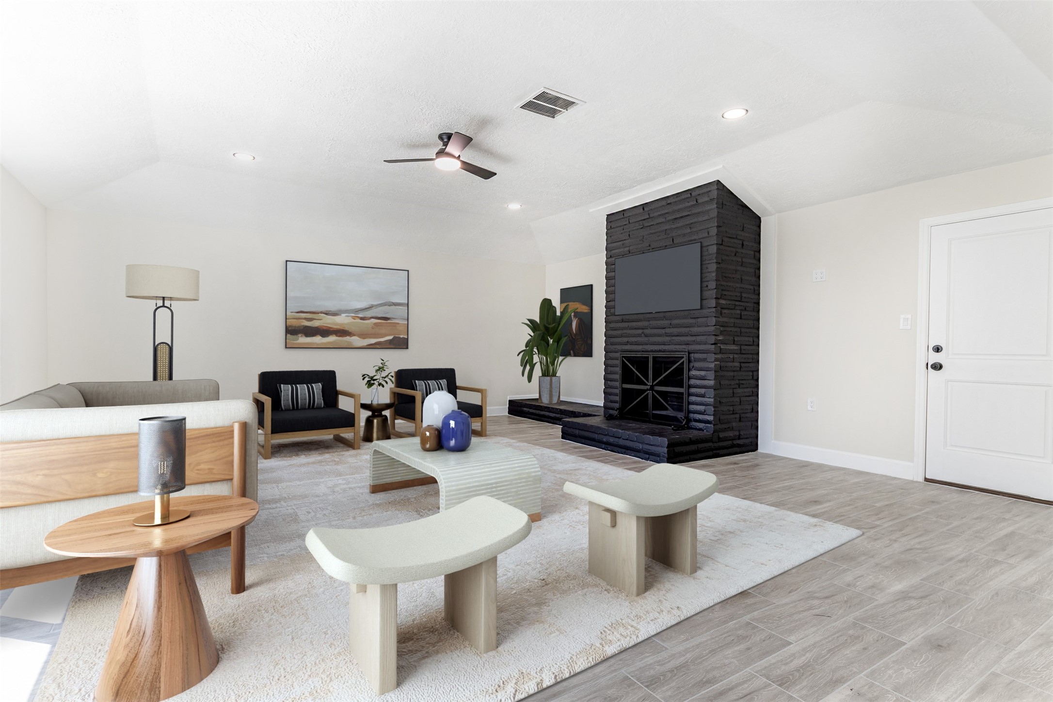 a living room with furniture a fireplace and a flat screen tv