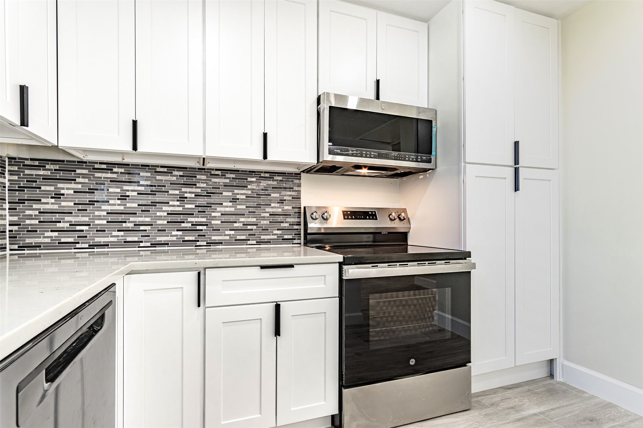 11203 Rousseau Drive Houston, TX 77065 - Photo 11 of 50 a kitchen with stainless steel appliances a stove and a microwave